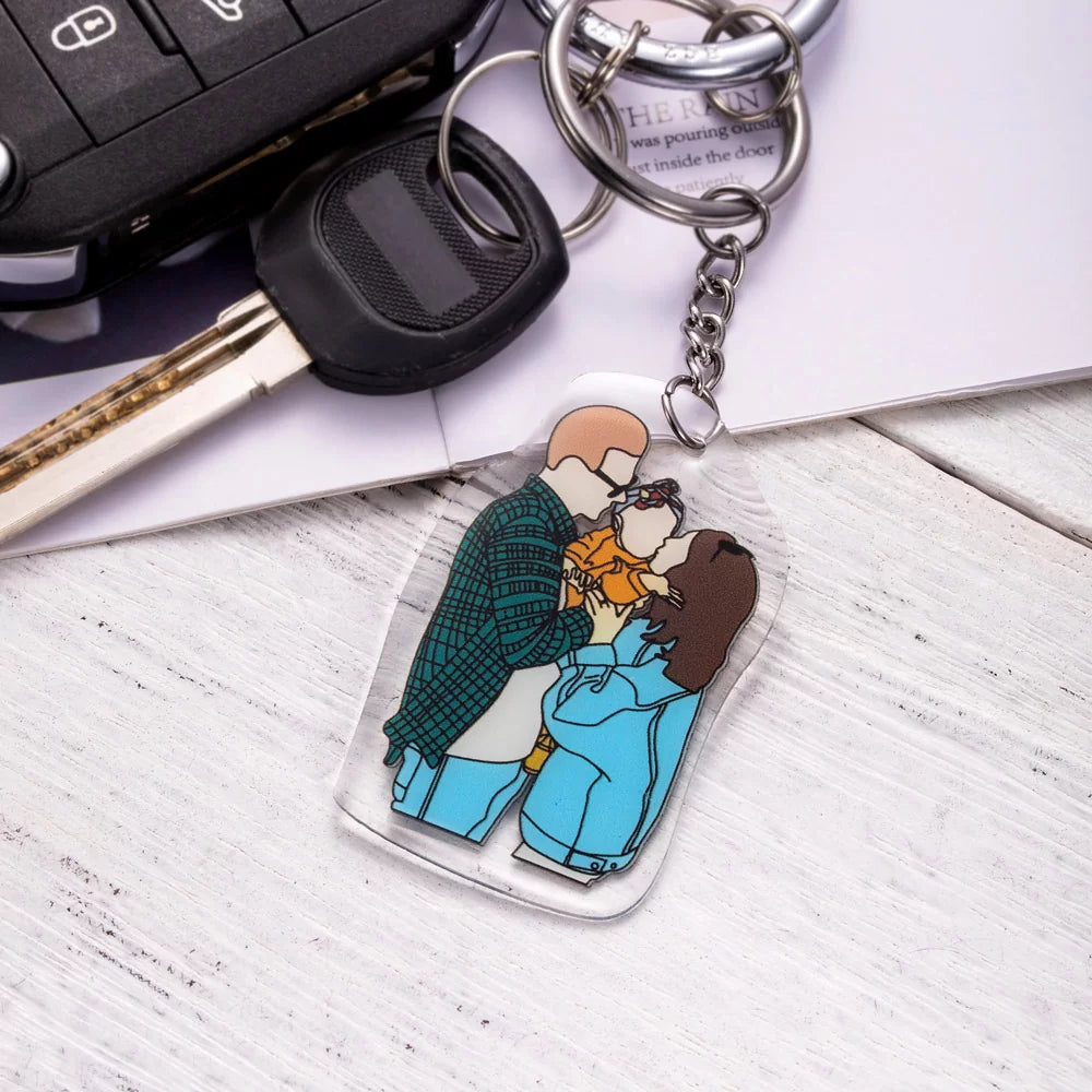 a custom of a faceless couple holding a faceless baby portrait keychain