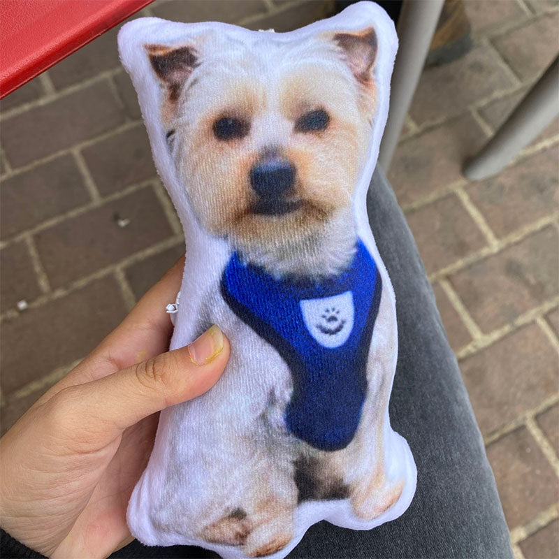 a woman hold a custom dog photo pillow shaped in her hand