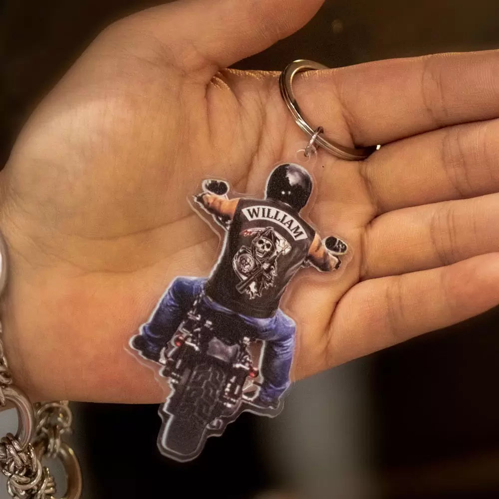 Custom name on the back of biker riding motorcycle keychain