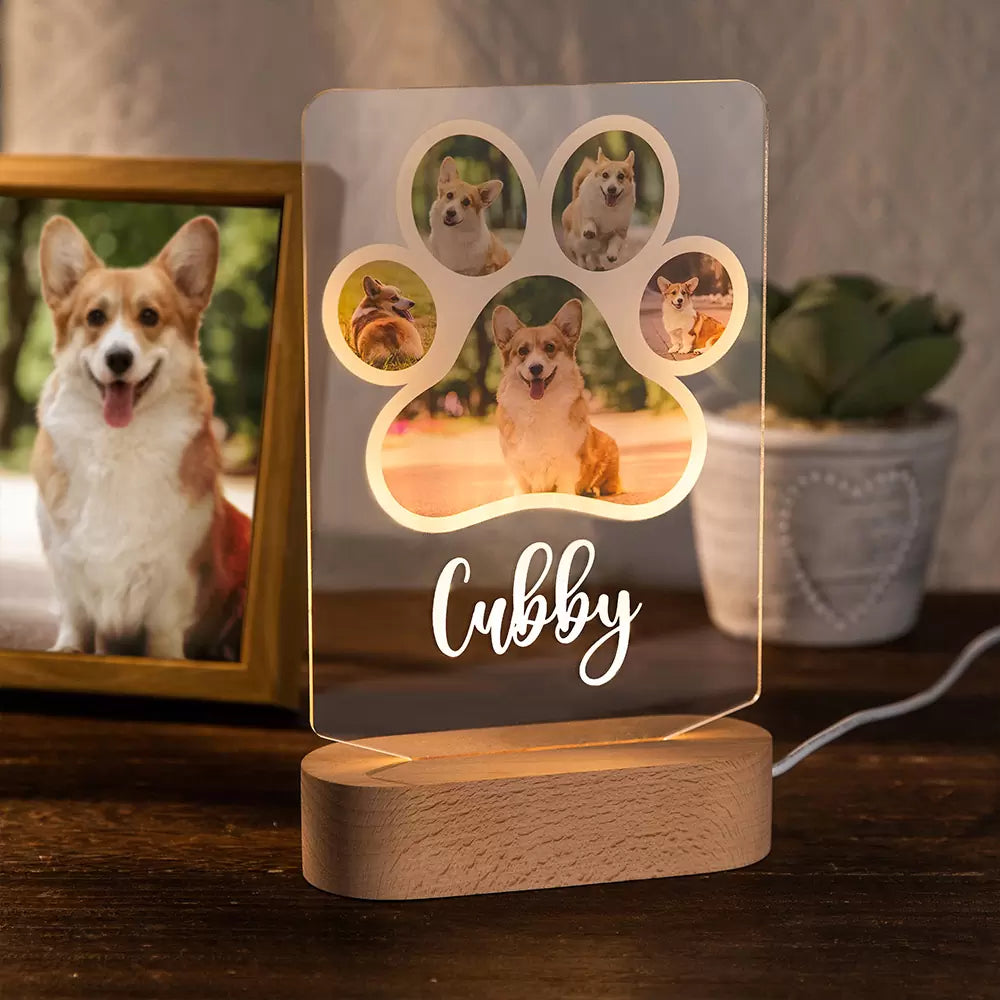 A personalized photo dog paw night light with a wooden base, featuring 5 images of a corgi and the name 'Cubby' engraved on the acrylic paw prints.