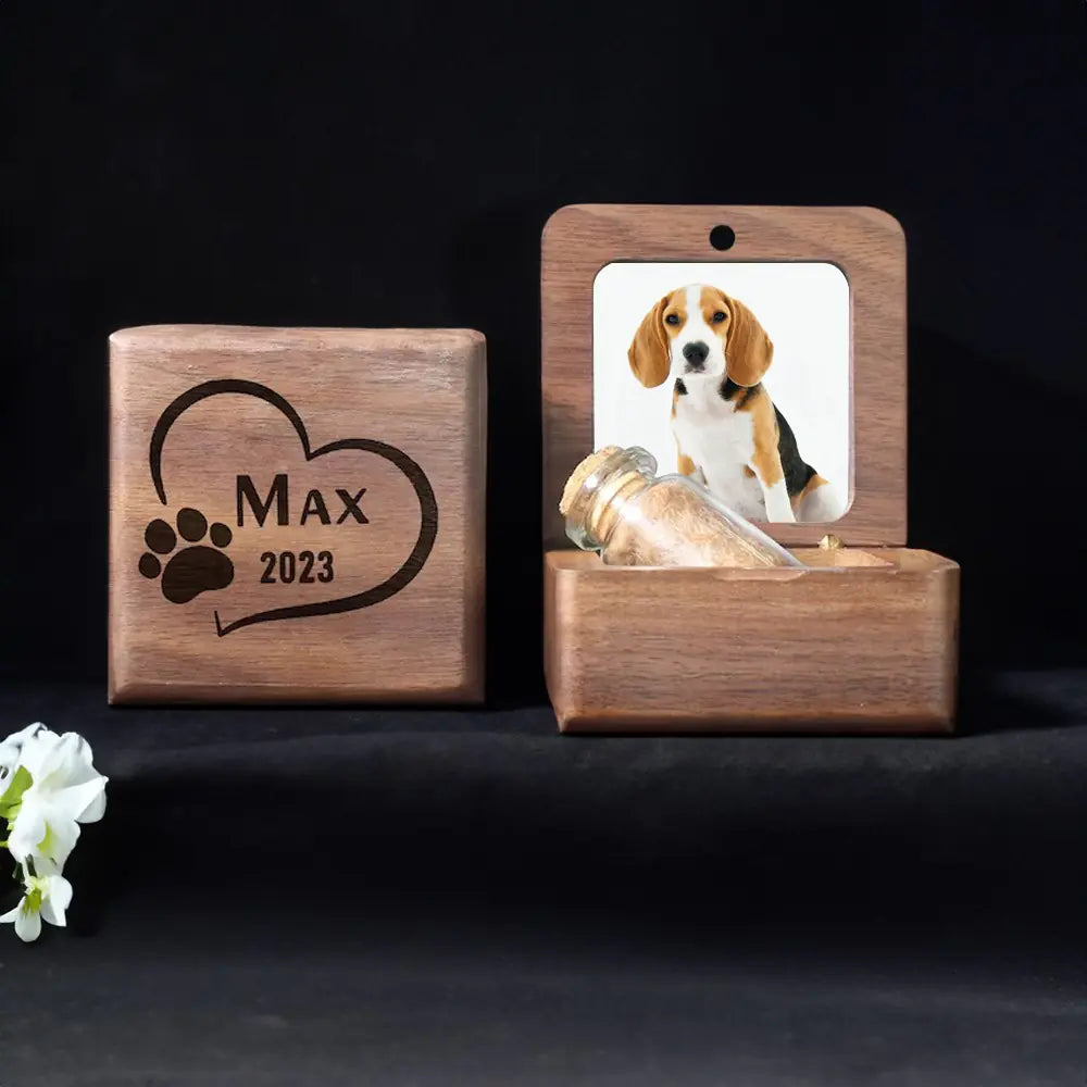 Wooden pet memorial with engraved name and year, featuring a photo of a dog on a black background.