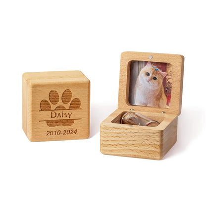 Wooden pet urn with a photo of a cat and engraved name and years on a white background