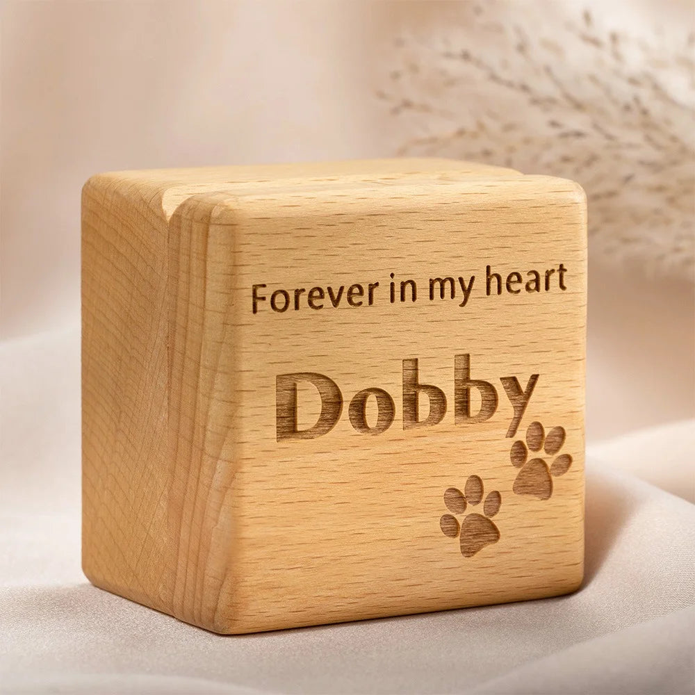 Wooden cube with engraved text 'Forever in my heart Dobby' on a soft background
