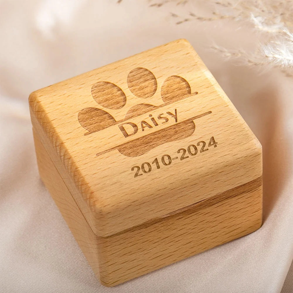 Mini wooden pet memorial box held in hand showing compact size and engraving detail