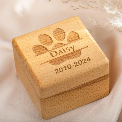 Mini wooden pet memorial box held in hand showing compact size and engraving detail