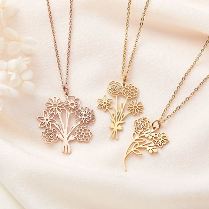 Three gold floral necklaces on a soft beige background