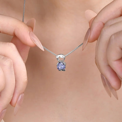Dainty sterling silver birthstone necklace with boy charm worn on model