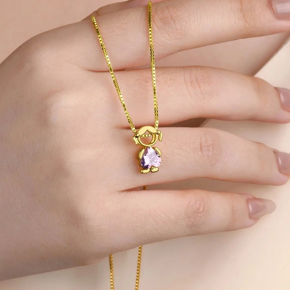 Minimalist gold girl charm with birthstone necklace worn on hand, new mom gift idea