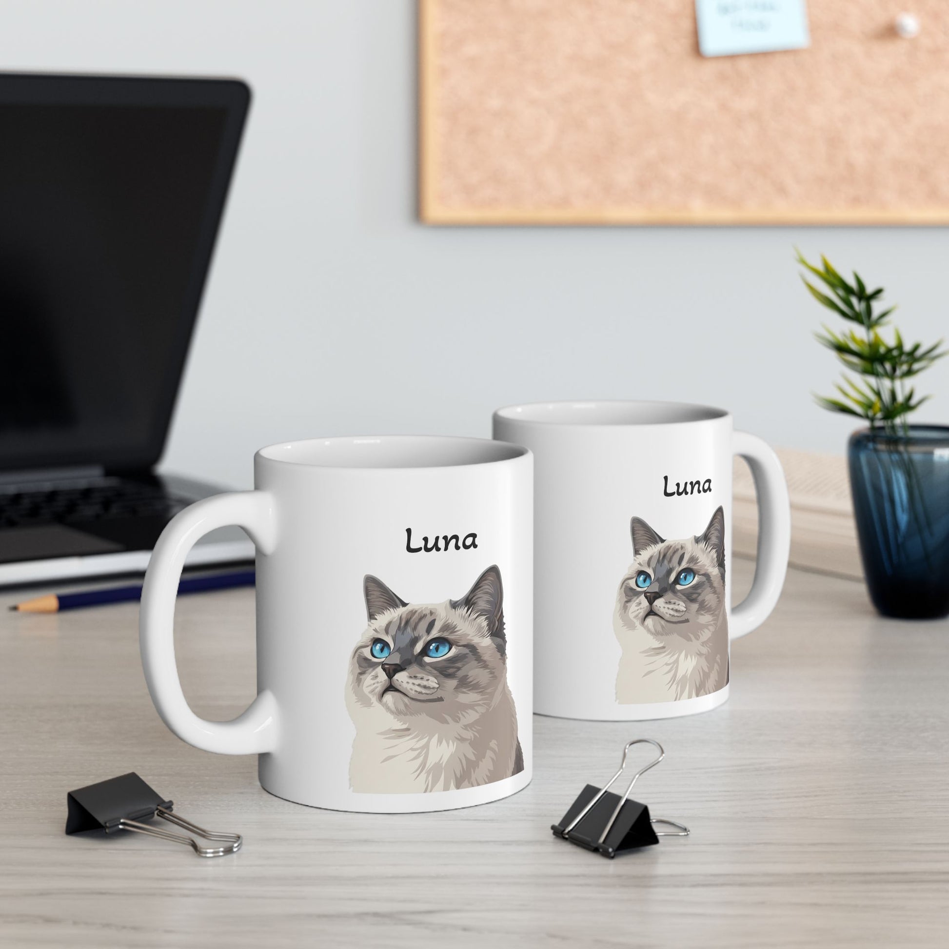 Two mugs with a cat illustration and 'Luna' text on a desk with office items.