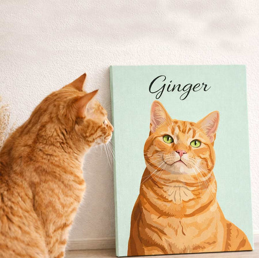 Orange cat looking at a custom cat portrait canvas leaning against a wall, featuring the cat named Ginger with a mint green background and script text at the top
