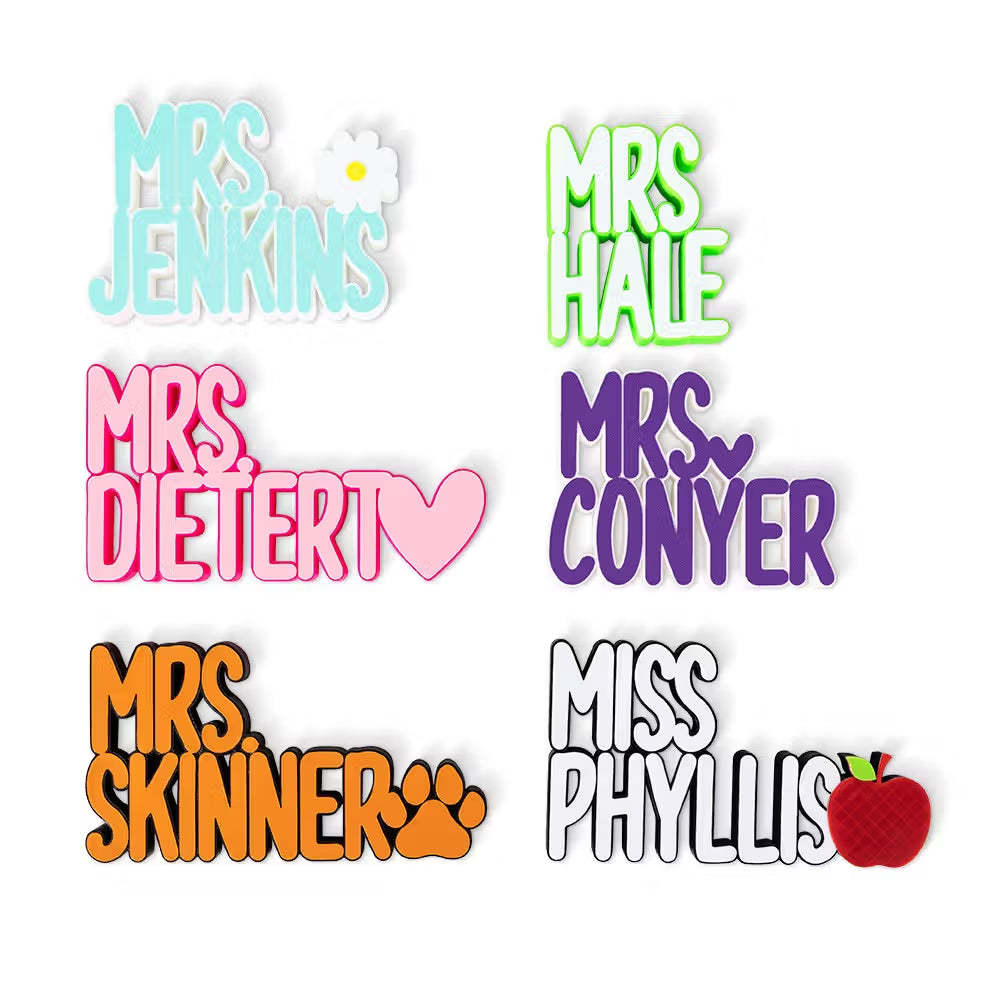 Multiple personalized 3D teacher name signs in different colors and icon designs displayed together

