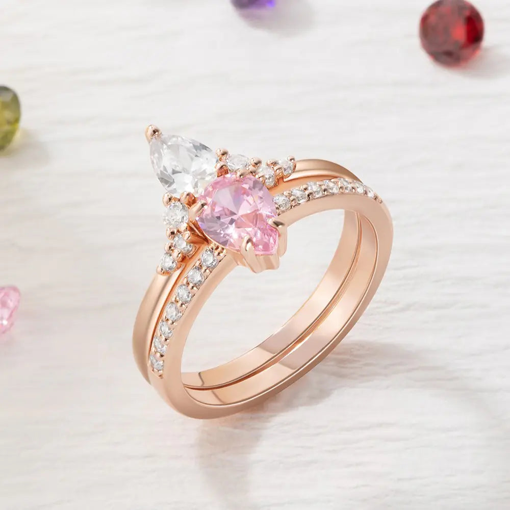 Rose gold personalized double birthstone ring featuring two pear-shaped stones in a delicate setting.