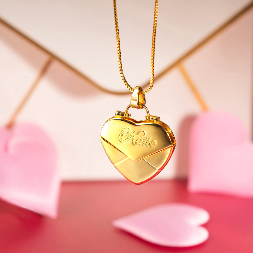 A gold custom heart shaped envelope  necklace with custom name "Katie"